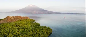 Sunrise illuminates the Iliape volcano found just east of Flores, Indonesia. This tropical area is part of the famous Ring of Fire