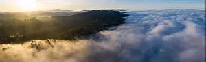 Sunrise illuminates the marine layer covering the entirety of San Francisco Bay. The foggy marine layer is an almost daily climatic phenomenon