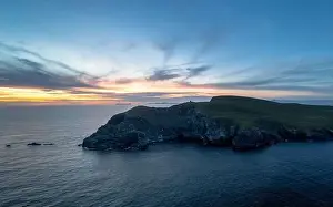 Sunset over the Atlantic Ocean and the cliffs of Bray Head on Valentia Island in County Kerry