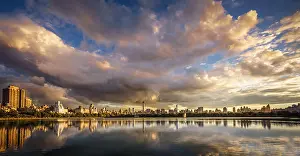 Midtown Manhattan Prints: Sunset over Central Park Jacqueline Kennedy Onassis Reservoir with Manhattan skyline reflection and a cloudy sky