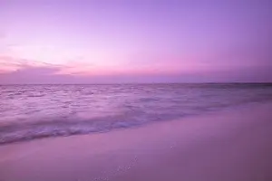 Sunset coastline seascape. Peaceful beach sand with calm sea view, horizon and colorful sky clouds. Tranquility, amazing, relaxing beach shore