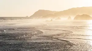 Sunset landscape with huge waves and mountain hills on horizon