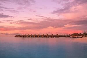 Images Dated 1st November 2019: Sunset on Maldives island, luxury water villas resort and wooden pier. Beautiful sky and clouds