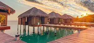 Sunset Beach Prints: Sunset on Maldives island, luxury water villas resort hotel and wooden pier