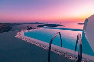 Images Dated 11th October 2019: Sunset poolside vacation at Santorini, infinity swimming pool looking over the caldera ocean of