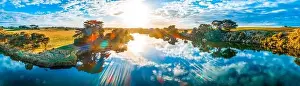 Sunset with sun flare over beautiful river in Australia - aerial panorama