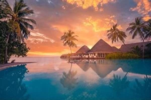 Images Dated 1st November 2019: Sunset tourism landscape. Luxurious beach resort with swimming pool reflection beach with palm trees