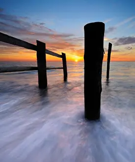 Blurred Motion Prints: Sunset on the west beach, fence and posts