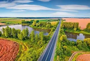 Superb summer sunrise on Ternopil outskirts with two lakes and asphalt road on the midle