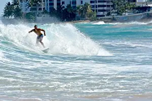 Water Sport Prints: Surfer riding waves at Condado beach in Puerto Rico