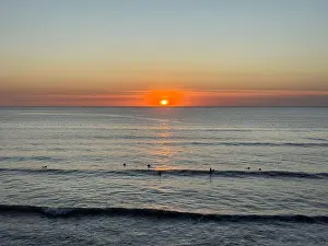 Surfers at Sunset, Widemouth Bay, North Cornwall, England, UK
