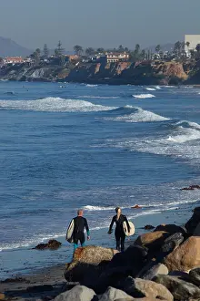 Surfers Prints: Surfers walking on the beach near Carlsbad, California, USA