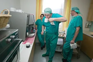 Face To Face Prints: surgeons having early morning cup of coffee before entering operating room