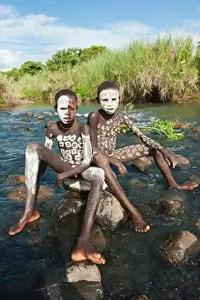 Ethnicity Prints: Two Surma boys with body paintings sitting on a rock in the river