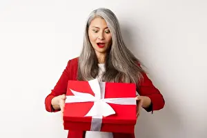 Employer Prints: Surprised asian senior woman receiving present on mother day