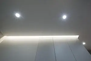 Stretch Prints: suspended or stretch ceiling with halogen spots lamps and drywall construction in empty room in apartment or house
