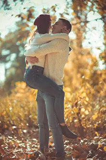 Stroll Prints: Sweet couple is in the park, hugging and looking very happy, enjoying the sunny day