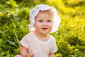 Offspring Prints: Sweet happy little baby girl sitting on grass in park