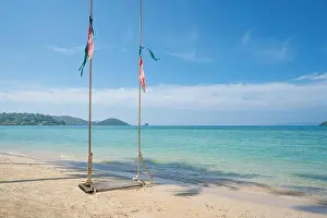 Swing hang from coconut palm tree over summer beach sea in Phuket, Thailand. Summer, Travel, Vacation and Holiday concept
