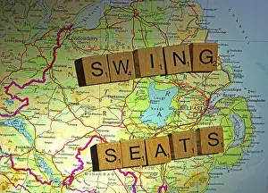 Parties Prints: Swing Seats in NI Northern Ireland spelt in Scrabble letters on a UK map - General Election