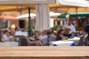 Houseboat Prints: Empty table with Blurred abstract background of outdoor cafe in Milan