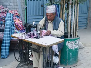 Sewing Machine Prints: tailor at work with his sewing machine in Kathmandu, Nepal