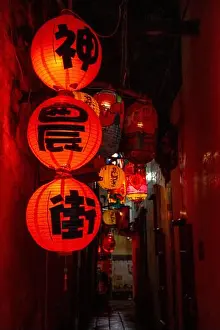 Night Scene Prints: Tainan, Taiwan – Jun 29, 2025: Traditional red lanterns hanging in a narrow alley on Shennong Street at night