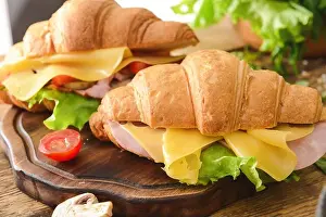 Croissant Prints: Tasty croissant sandwiches on wooden board