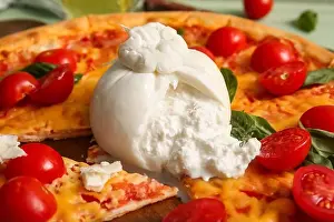 Tasty pizza with Burrata cheese, closeup
