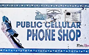 Africans Prints: A tattered poster advertises a public cellular phone shop in Langa African township near Cape Town