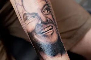 Forearm Prints: Tattoo of actor Jack Nicholson in his The Shining role