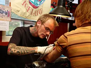 Occupations Prints: Tattoo artist creating new tattoo on arm, Reykjavik, Iceland
