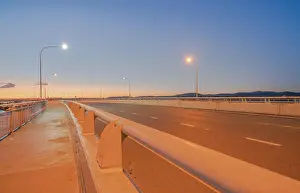 Travel Image Prints: Tauranga Harbour Bridge transport route with road and pedestrian and cycle path with glow of cyclists