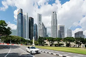 Hired Prints: Taxi cab driving in road in Singapore downtown with Singapore skyscrapers building in background