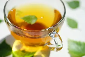 Remedy Prints: Tea in a glass cup with a birch leaf
