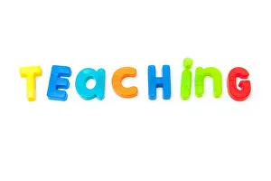Magnetic Prints: Teaching written in magnetic letters isolated on a white studio background