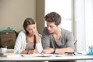 Teens Prints: Teen boy and girl sitting together and studying