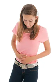 Teen girl with belly ache isolated over white background
