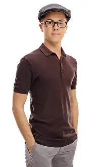 Teenage boy in a retro outfit looking at the camera isolated on white background
