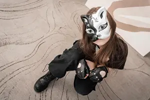 Agility Prints: Teenage girl with cat mask and gloves doing Quadrobics. High quality photo