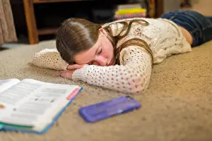 Exhausted Prints: Teenage girl falls asleep on ground while studying