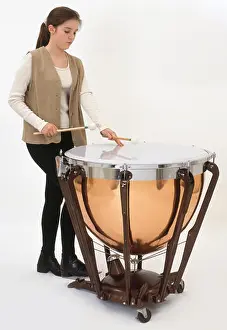 Ponytail Prints: Teenage girl playing timpani drum, close-up