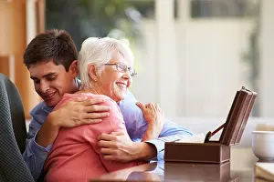Seniors Prints: Teenage Grandson Hugging Grandmother