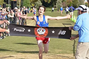 Finish Line Prints: teenager crosses the finish line after running in a high school cross country match