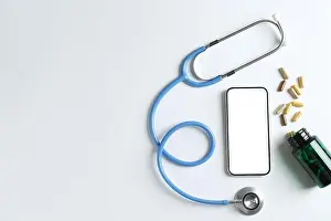 Pills Prints: Telehealth. Smartphone, stethoscope and pills on light background