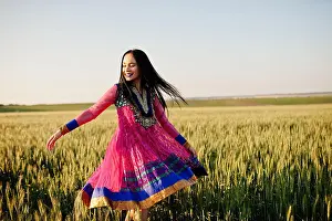 Saree Prints: Tender indian girl in saree, with violet lips make up posed at field in sunset