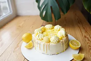 Vanilla Prints: Tender lemon cake with candid lemon and meringue on wooden table