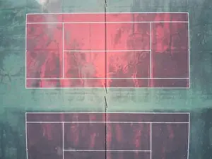Background Texture Prints: Empty tennis court aerial view showing a red surface court with green edges and white marking lines