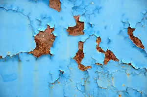 Distressed Prints: Texture of old grungy blue paint peeling-off rusted metal surface