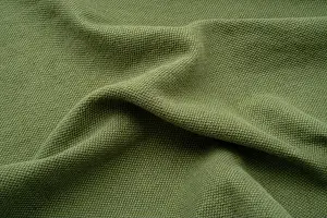 Rippled Prints: Textured fabric background. An olive green coloured ruched up linen
